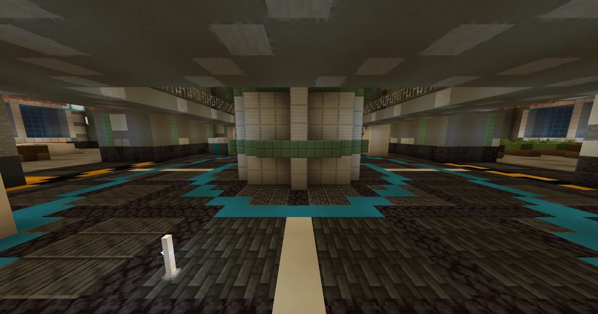 A round hall with a reactor pillar, a teal ring in the floor and panelled pale walls.